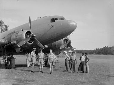 [Aircraft and several men standing in front of it]