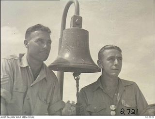 PORT MORESBY, PAPUA. C. 1944. TWO MEMBERS OF THE RAAF RESCUE SERVICE. ALSO SHOWN IS THE SHIP'S BELL SALVAGED FROM THE MV MACDHUI WHICH WAS THE TARGET OF ATTACKS BY JAPANESE BOMBER AIRCRAFT ON ..