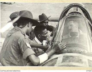 BOUGAINVILLE ISLAND. 1944-12-23. FLYING OFFICER R.H. ARMSTONG, NO. 16 SQUADRON, ROYAL NEW ZEALAND AIR FORCE SHOWING TROOPS OF THE 1ST INDIAN HEAVY ANTI-AIRCRAFT REGIMENT THE COCKPIT OF HIS ..