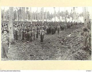 MADANG, NEW GUINEA. 1944-07-01. A JOIN-UP PHOTOGRAPH OF A MORNING PARADE OF THE 24TH INFANTRY BATTALION. TO JOIN TO PHOTOGRAPHS NO. 74438, 74439 AND 74440. IDENTIFIED PERSONNEL ARE:- STAFF SERGEANT ..