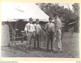 BUIN AREA, BOUGAINVILLE. 1945-09-13. JAPANESE STAFF OFFICERS, AN INTERPRETER AND A STAFF OFFICER OF 2 CORPS OUTSIDE THE MARQUEE AT KAHILI BEACH AT HEADQUARTERS 2 CORPS SURRENDER PARTY CAMP. ..