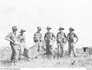 WEWAK POINT, NEW GUINEA, 1945-05-12. LT-COL G.S. COX, COMMANDING OFFICER 2/4 INFANTRY BATTALION (4), WITH LT-COL R.F. JABOOR, 2/2 FIELD REGIMENT, ROYAL AUSTRALIAN ARTILLERY (2), AND SOME OF HIS ..