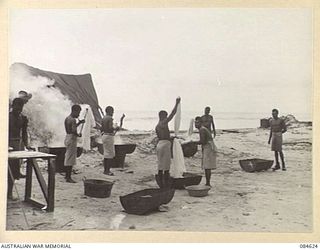 GREEN ISLAND, BOUGAINVILLE AREA, SOLOMON ISLANDS. 1944-12-19. PRIVATE A E HUTCHINSON, HQ 17 FIELD AMBULANCE, (1), IN CHARGE OF NATIVE HELPERS WORKING AT THE HOSPITAL LAUNDRY. THE LAUNDRY IS ..