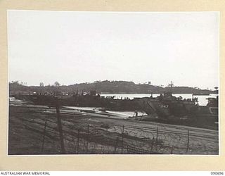 AITAPE, NEW GUINEA. 1945-04-19. SUPPLIES BEING UNLOADED FROM BARGES AT THE BEACH HEAD