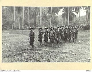 SIAR, NEW GUINEA. 1944-06-23. PERSONNEL OF NO.18 PLATOON, D COMPANY, 57/60TH INFANTRY BATTALION MOVING OFF THE UNIT PARADE GROUND AT THE CONCLUSION OF THE MORNING PARADE. IDENTIFIED PERSONNEL ARE:- ..