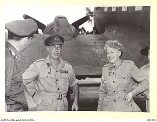 PIVA AIRSTRIP, TOROKINA, BOUGAINVILLE, 1945-08-15. GRACIE FIELDS (3), BEING WELCOMED BY LIEUTENANT-GENERAL S.G. SAVIGE, GENERAL OFFICER COMMANDING 2 CORPS (2), ON ARRIVAL AT HEADQUARTERS 2 CORPS ..
