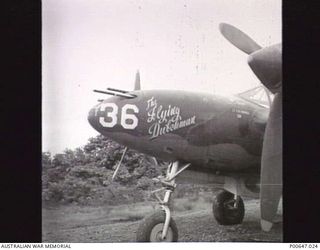 MILNE BAY, PAPUA, C.1943-04. CLOSE UP OF NOSE ART OF P38 AIRCRAFT "THE FLYING DUTCHMAN" IN DISPERSAL BAY AT NO. 3 STRIP. (TURNBULL FIELD). (DONOR - T. G. JONES.)