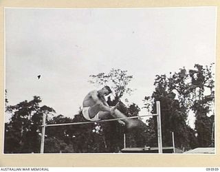 TOROKINA, BOUGAINVILLE, 1945-07-15. SERGEANT MCCRACKEN, 7 ARMY TROOPS COMPANY, WHO CAME SECOND IN THE HIGH JUMP, AT THE COMBINED ALLIED SPORTS CHAMPIONSHIP MEETING AT GLOUCESTER OVAL ARRANGED BY ..