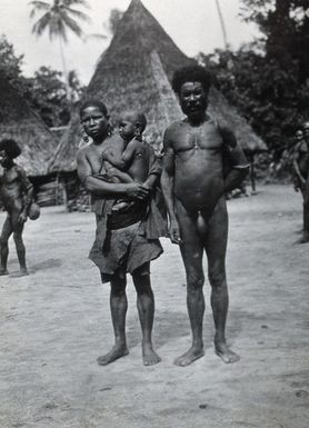 ["Papua New Guinea (?): a man with a woman and child. Photograph by E.W. Pearson Chinnery (?)."]