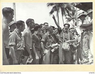 JACQUINOT BAY, NEW BRITAIN. 1945-03-11. A BOOKMAKER CALLING THE ODDS DURING THE AQUATIC CARNIVAL OF THE NEW BRITAIN YACHT CLUB, 5TH BASE SUB AREA