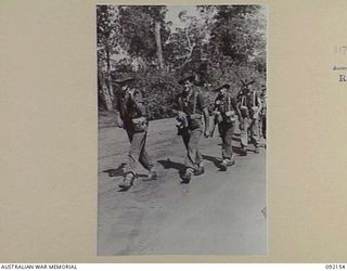 WEWAK AREA, NEW GUINEA. 1945-05-13. TROOPS OF 2/8 INFANTRY BATTALION MARCHING ALONG BORAM BEACH NEAR WEWAK ON THEIR WAY TO RELIEVE THE 2/4 INFANTRY BATTALION. IDENTIFIED PERSONNEL ARE:- CORPORAL G. ..