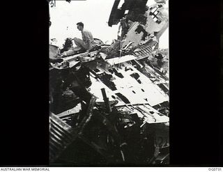 LAE, NEW GUINEA. C. 1944-02. JAPANESE AIRCRAFT THAT WERE ON THE AIRSTRIP AT LAE AND WERE STRAFED BY RAAF BOSTON AND BEAUFIGHTER AIRCRAFT HAVE NOW BEEN PUSHED TO ONE SIDE AND THE AIRFIELD IS USED BY ..