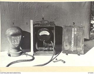 LAE, NEW GUINEA. 1944-06-02. JAPANESE RESPIRATORY EQUIPMENT AT HEADQUARTERS NEW GUINEA FORCE WHICH WAS CAPTURED IN MADANG DURING MAY 1944. THE SIZE OF THE EQUIPMENT CAN BE GAUGED FROM THE RULER IN ..