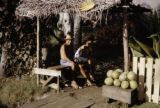 French Polynesia, people selling melons at roadside on Tahiti Island