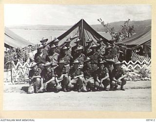 WEWAK POINT, NEW GUINEA. 1945-10-02. A FORMAL GROUP OF NO. 12 PLATOON, C COMPANY, 2/3 MACHINE-GUN BATTALION. THE GROUP HAS THREE DECORATED MEN: SERGEANT E. HAYLETT, MILITARY MEDAL; LIEUTENANT H.H. ..