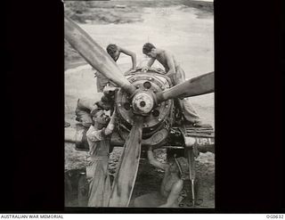 KIRIWINA, TROBRIAND ISLANDS, PAPUA. 1944-01-31. GROUND STAFF AT NO. 79 (SPITFIRE) SQUADRON RAAF OVERHAULING THE ROLLS ROYCE MERLIN ENGINE OF ONE OF THE SQUADRON AIRCRAFT