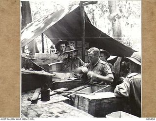 FINSCHHAFEN AREA, NEW GUINEA. 1943-11-13. SUPPLIES BEING ISSUED ON THE DAY THE NEW CANTEEN ISSUING POINT, FOWARD AREA, WAS OPENED