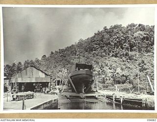 BALASANA, NEW GUINEA, 1943-07-06. NEW VESSEL NEARING COMPLETION ON THE SLIPWAYS OF THE 1ST AUSTRALIAN WATER TRANSPORT GROUP MAINTENANCE BASE