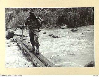 FARIA VALLEY, NEW GUINEA, 1944-02-10. TX2013 LIEUTENANT COLONEL C.J. GEARD, COMMANDING OFFICER OF THE 2/10TH INFANTRY BATTALION, CROSSING THE FARIA RIVER AT IRIE, AFTER HIS BATTALION HAD BEEN ..