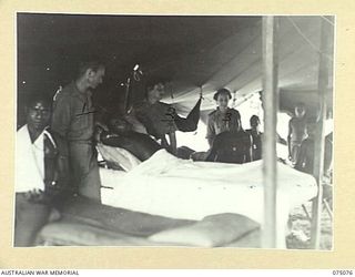 SOUTH ALEXISHAFEN, NEW GUINEA. 1944-08-08. PERSONNEL OF THE 111TH CASUALTY CLEARING STATION WORKING IN THE NATIVE WARD. IDENTIFIED PERSONNEL ARE:- S26416 PRIVATE R.H. POWELL (1); NFX70502 SISTER ..