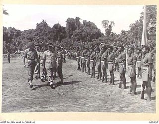 TOROKINA, BOUGAINVILLE. 1945-10-22. A CEREMONIAL PARADE AND MARCH PAST BY PAPUAN INFANTRY BATTALION WAS HELD FOR MAJOR GENERAL W. BRIDGEFORD, GENERAL OFFICER COMMANDING 3 DIVISION. SHOWN, MAJOR ..