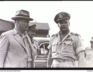 LAE AIRSTRIP, NEW GUINEA, 1946-01-27. THE HONOURABLE F. M. FORDE, MINISTER FOR THE ARMY, TALKING TO SQUADRON LEADER J. W. MALONEY, COMMANDING OFFICER NO 33 SQUADRON RAAF, AT THE AIRSTRIP. MR FORDE ..