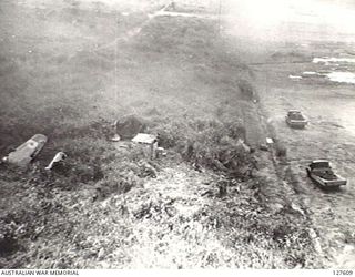 VUNAKANOU, NEW GUINEA. 1943-10-24. VIEW FROM FIFTH AIR FORCE, UNITED STATES ARMY AIR FORCE BOMBER RUNNING DOWN THE STRIP AT ZERO ALTITUDE WITH THE WRECKAGE OF A RAAF BOMBER IN THE FOREGROUND