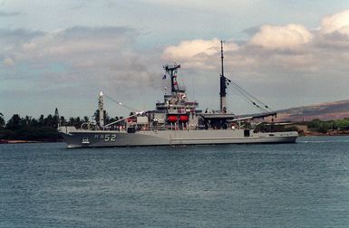 The salvage ship USS SALVOR (ARS-52) moves through the channel as it departs from the naval station.