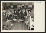 Sgt. Isamu Sanemitsu with his fellow patients takes his mess in the ward at Moore General Hospital, Swannanoa, North Carolina
