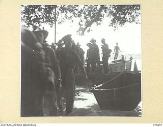 DREGER HARBOUR, NEW GUINEA. 1944-01. WALKING PATIENTS FROM LAUNCH JETTY, (A COVE JUST NORTH OF FINSCHHAFEN), EN ROUTE TO THE 10TH FIELD AMBULANCE, AUSTRALIAN ARMY MEDICAL CORPS, DISEMBARKING FROM ..