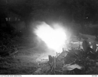 BARGES HILL, CENTRAL BOUGAINVILLE, 1945-06-26. A TROOP, 10 BATTERY, 4 FIELD REGIMENT, IS CONTINUOUSLY HARASSING THE JAPANESE WITH FIRE AND GIVING THEM NO REST DAY OR NIGHT. SHOWN, LAYING HARASSING ..