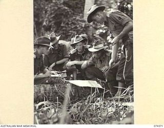 SIAR, NEW GUINEA. 1944-06-25. OFFICERS OF A COMPANY, 57/60TH INFANTRY BATTALION RECEIVING THEIR INSTRUCTIONS BEFOR EMBARKING ON THEIR OPERATIONS AGAINST THE ENEMY. IDENTIFIED PERSONNEL ARE:- ..