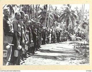 SIAR, NEW GUINEA. 1944-06-27. TROOPS OF THE 15TH INFANTRY BRIGADE LINED UP DURING ONE OF THE UNIT MESS PARADES