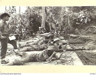 SIAR, NEW GUINEA. 1944-06-25. TROOPS OF D COMPANY, 57/60TH INFANTRY BATTALION FIRING FROM THE 30 YARD MOUND ON THE UNIT RIFLE RANGE. IDENTIFIED PERSONNEL ARE:- CORPORAL CAPUANO (1); PRIVATE BOOTH ..