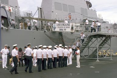 Chinese Liberation Navy Sailors come aboard the guided missile destroyer USS O'KANE (DDG 77) for a tour, during a port visit to Pearl Harbor, Hawaii