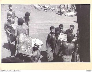 DUMPU, NEW GUINEA. 1944-05-19. PERSONNEL FROM HEADQUARTERS 11TH DIVISION, ASSISTED BY NATIVE LABOUR, LOADING AN AIRCRAFT AT THE AIRFIELD FOR THE JOURNEY TO WAU. THE 11TH DIVISION, WHICH TOOK OVER ..