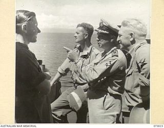 SEK ISLAND, NEW GUINEA. 1944-04-27. OFFICIAL WAR CORRESPONDENTS ON THE BRIDGE OF THE CORVETTE HMAS BUNDABERG BOUND FOR ALEXISHAFEN FROM SEK ISLAND. IDENTIFIED PERSONNEL ARE:- MR ROY MACARTNEY (1); ..