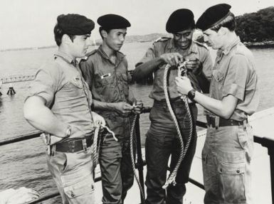 Two Australian army officers and two Fijian navy officers splice a rope, Sydney, 1976 / John Tanner