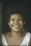 Smiling young woman with dashes of betel nut paste on her cheeks