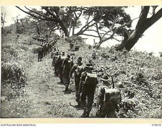 DAGUA, NEW GUINEA. 1945-03-25. MEMBERS OF B COMPANY, 2/2ND INFANTRY BATTALION, MOVING FROM THEIR BIVOUAC AREA TO RELIEVE A COMPANY IN THE TORRICELLI RANGES OVERLOOKING THE AIRSTRIP