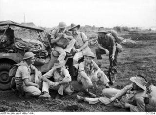 MOROTAI ISLAND, HALMAHERA ISLANDS, NETHERLANDS EAST INDIES. C. 1945-06-25. RAAF MEN OF A REFUELLING UNIT WHO HAVE WORKED ON AIRSTRIPS FROM MILNE BAY TO BORNEO, RELAX WHILE WAITING THEIR TURN TO ..