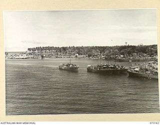 MADANG, NEW GUINEA. 1944-05-12. THE VIEW FROM AN AMERICAN MERCHANT "LIBERTY" SHIP LOOKING DUE EAST TOWARDS MADANG. THE ENTRANCE TO THE HARBOUR IS VISIBLE AT THE LEFT NEAR TENTS HOUSING THE 111TH ..