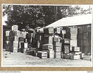 17 MILE, LALOKI RIVER, NEW GUINEA. 1943-11-22. A STACK OF EMPTY BOTTLES OUTSIDE THE CORDIAL FACTORY ESTABLISED AND OPERATED BY THE AUSTRALIAN DEFENCE CANTEEN SERVICES ATTACHED TO HEADQUARTERS, NEW ..