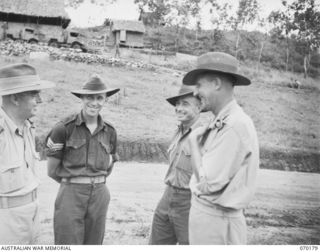 PORT MORESBY, NEW GUINEA. 1944-02-07. NX34952 CHAPLAIN F.H. GALLAGHER, (ROMAN CATHOLIC CHAPLAIN AT THE MORESBY BASE SUB-AREA) (1), MAKING FINAL ARRANGEMENTS WITH THE REGIMENTAL SERGEANT MAJOR AND ..