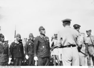 NAMATANAI, NEW IRELAND. 1945-09-19. THE SURRENDER OF GENERAL ITO (FOURTH FROM LEFT), COMMANDER IN CHIEF OF JAPANESE FORCES ON NEW IRELAND, TO MAJOR GENERAL K. W. EATHER CB CBE DSO ED, GENERAL ..