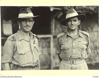 BUNA, NEW GUINEA. 1944-04-18. QX6172 CAPTAIN A. SKINNER, DCM, MM, ADJUTANT AND ACTING COMMANDING OFFICER, NEW GUINEA DETAILS DEPOT (1), WITH NX142200 SERGEANT E.W. GREGORY (2); A NON COMMISSIONED ..