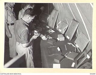 LAE AREA, NEW GUINEA. 1945-06-03. SPECTATORS INSPECTING SAMPLES OF WOODWORK AT AN EXHIBITION OF HOBBIES AND CRAFTS AT 112 CONVALESCENT DEPOT