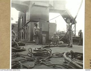 NEW GUINEA. 1944-06-15. CREW MEMBERS OF THE AB442 A VESSEL OF THE 12TH WATER TRANSPORT OPERATING COMPANY, WORKING AMIDSHIPS SORTING, CHECKING AND RESPLICING THEIR ROPES AND LANYARDS