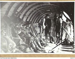 WARD'S DROME, PORT MORESBY AREA, PAPUA, NEW GUINEA. 1944-01-05. TROOPS OF THE 2/11TH AUSTRALIAN LIGHT ANTI-AIRCRAFT BATTERY, 2/4TH AUSTRALIAN LIGHT ANTI-AIRCRAFT REGIMENT LOADING THEIR RIFLES AND ..