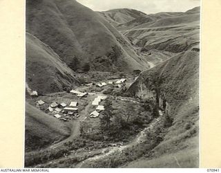 ZENAG, NEW GUINEA, 1944-02-27. CAMP SITE OF THE 2/9TH FIELD COMPANY, ROYAL AUSTRALIAN ENGINEERS,PHOTOGRAPHED FROM THE ROADWAY WHICH LEAVES THE CAMP TOWARDS WAMPIT. FOURTY-ONE AND A HALF MILES FROM ..